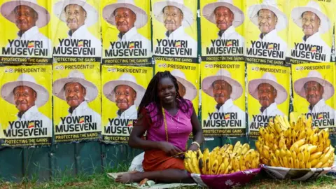 Reuters A woman sells bananas near campaign posters of Uganda's President and the leader of ruling National Resistance Movement (NRM) party, Yoweri Museveni, following the general elections in Kampala, Uganda January 17, 2026