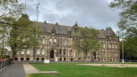 LDRS Middlesbrough Town Hall. A large, two-storey building with an arched roof and many windows, and a large lawn in front.
