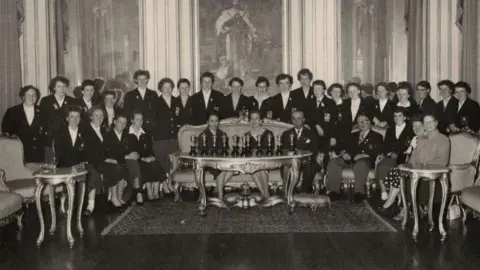 Anne Grimes The Corinthians are standing side by side with some seated in this photograph at the British Embassy in Lisbon in Portugal 1957. 