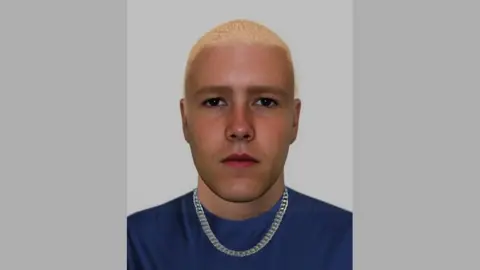 A photo fit of a white man in his twenties with slightly tanned skin, and of a slim, muscular build with brown eyes, shaved bleach blond hair and strong facial features of jawline and nose and thick eyebrows. He is wearing a thick silver link chain and navy t-shirt.