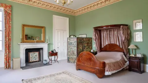 Knight Frank A bedroom with double bed, fireplace and mirror