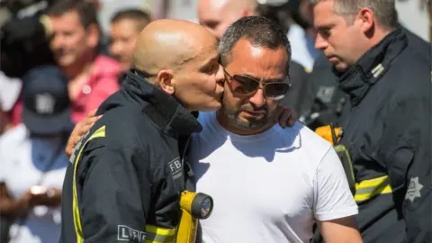 PA Media Friends - firefighter Dave Badillo and Manfred ‘Manny’ Ruiz (in white t-shirt)