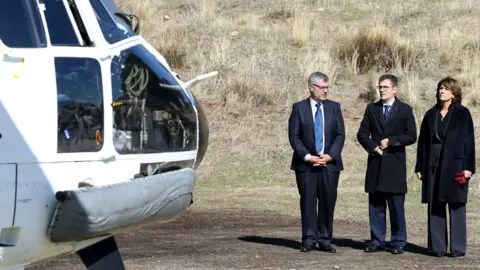 Getty Images Secretary of State Communication Miguel Ãngel Oliver (L), General Secretary of the Prime Minister"s office Felix Bolanos (C) and Caretaker Justice Minister Dolores Delgado watch as the coffin of Francisco Franco arrives at the Mingorrubio El Pardo cemetery