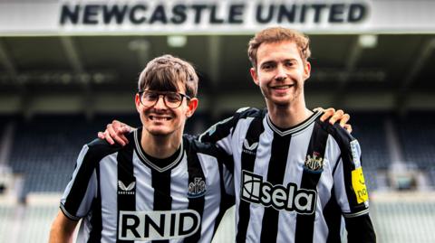 Newcastle United fans David Wilson (left) and Ryan Gregson with Sela's haptic shirts 