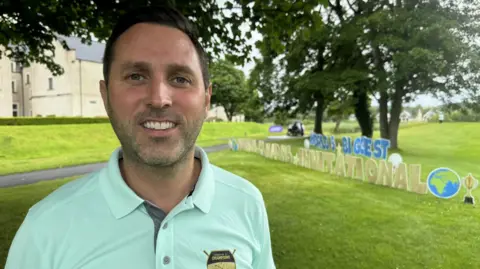 Michael Gallagher wearing a sky blue polo shirt