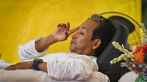 : Climate activist Sonam Wangchuk continues his indefinite hunger strike during an ongoing protest at Jantar Mantar on July 13, 2026 in New Delhi, India. The demonstration, led by the Cockroach Janta Party (CJP), demands the resignation of Union Education Minister Dharmendra Pradhan over alleged irregularities in competitive examinations, as concerns grow over Wangchuk's deteriorating health after more than two weeks of fasting. (Photo by Sanchit Khanna/Hindustan Times via Getty Images)