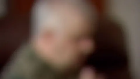 Blurred out image of the side view of a man's face