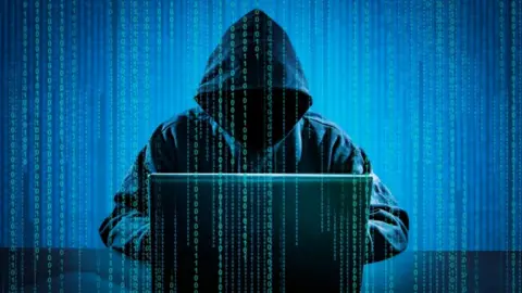 Getty Creative Stock Illustration of computer crime using a hooded character at a laptop