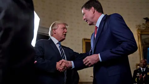 Getty Images Donald Trump and James Comey shake hands.