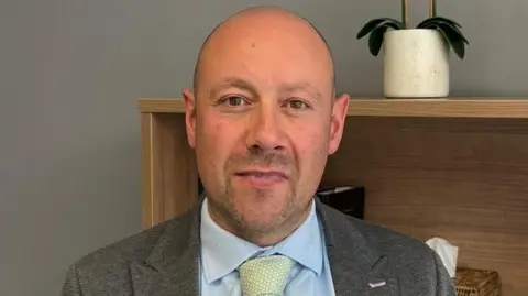 Thompsons Solicitors Paul Kissen of Thompsons Solicitors, man in shirt, tie and jacket, looking at camera.