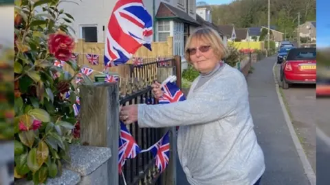 Deborah Stanyon Denise Sage putting up Union Jack bunting in Porlock