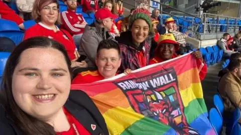 Tracy Brown Tracy Brown and friends holding rainbow flag