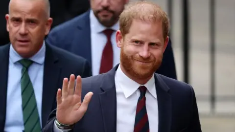 Prince Harry smiles and waves 