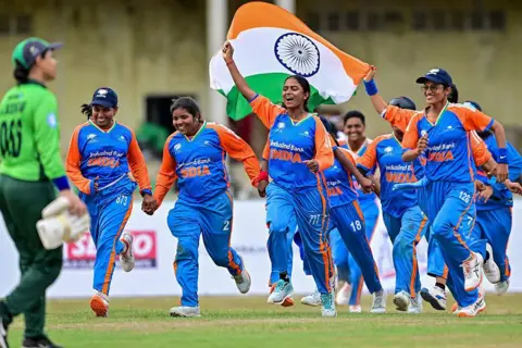 AFP via Getty Images India's players celebrate after their team's victory in the Women's Blind Twenty20 World Cup 2025 match against Pakistan at the BOI Cricket Stadium in Katunayake on November 16, 2025. (Photo by Ishara S. KODIKARA / AFP) (Photo by ISHARA S. KODIKARA/AFP via Getty Images)
