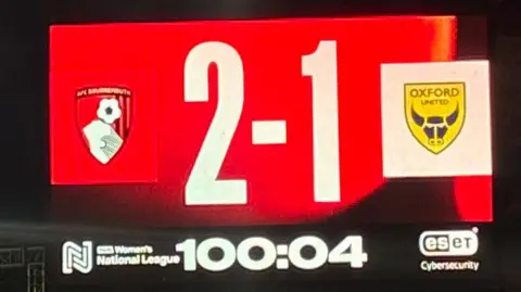 The illuminated score board at Vitality Stadium showing a white 2-1 against a red background