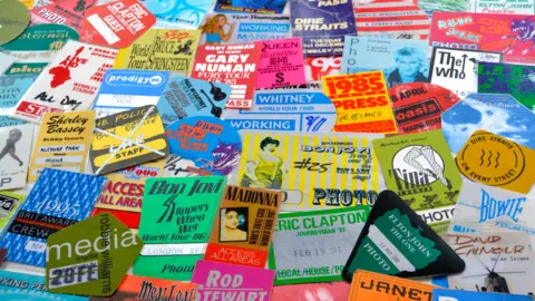 Getty Images A collection of old, colourful concert tickets and posters. Many famous names are included such as Tina Turner, Madonna, Bon Jovi, Bowie, Shirley Bassey and David Gilmour. 