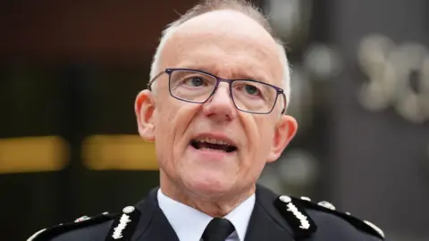 James Manning/PA Wire Metropolitan Police Commissioner Sir Mark Rowley in uniform, standing outside Scotland Yard 