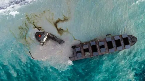 Getty Images An aerial view taken in Mauritius on August 17, 2020, shows the MV Wakashio bulk carrier, belonging to a Japanese company but Panamanian-flagged, that had run aground and broke into two parts near Blue Bay Marine Park.