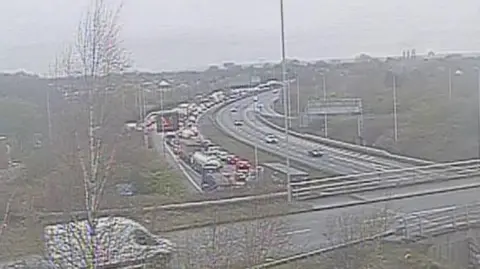 A build-up of traffic can be seen on the motorway from over a bridge.