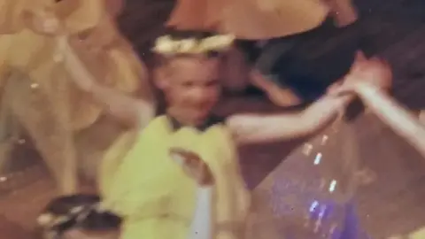 Grace Wallace An old picture of a young girl in a buttercup dress