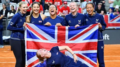 Great Britain's players celebrate qualifying for the 2024 Billie Jean King Cup Finals