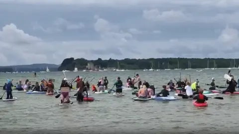 Surfers Against Sewage Paddleboarders on the water in Sandbanks