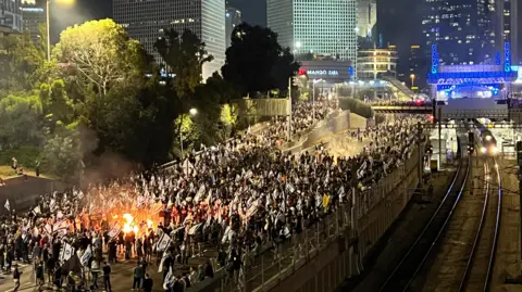 Aviv Atlas A crowd of protesters walk down the Ayalon Highway in Tel Aviv demonstrating against Gallant's dismissal on 5/11