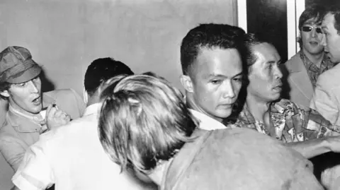 Getty The band are jostled at the Manila Airport