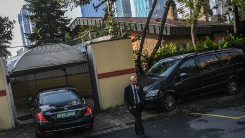 AFP A security member of the consulate stands guard as a diplomatic vehicle arrives at the Saudi Arabian consulate in Istanbul on October 12, 2018