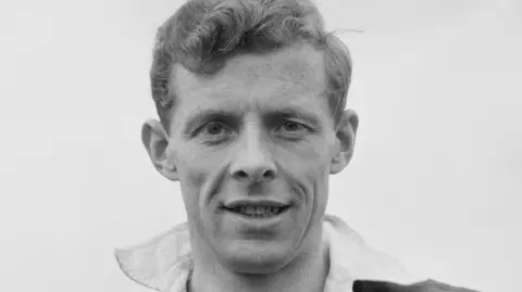 A black and white picture of rugby player Arthur Smith with curly hair