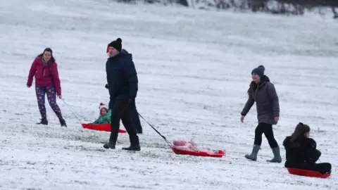 PA Media People sledging on Camp Hill, Woolton, Liverpool