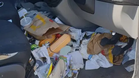 Thames Valley Police Van footwell full of rubbish.