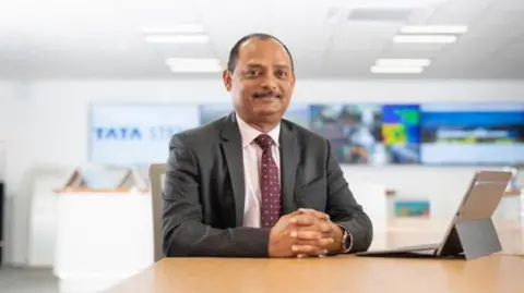 Tata Steel UK Rajesh Nair sitting at a desk