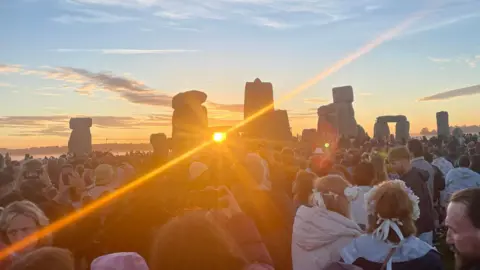 Crowds gather at Stonehenge to celebrate the summer solstice.