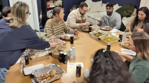 A group of people eating food at a workshop