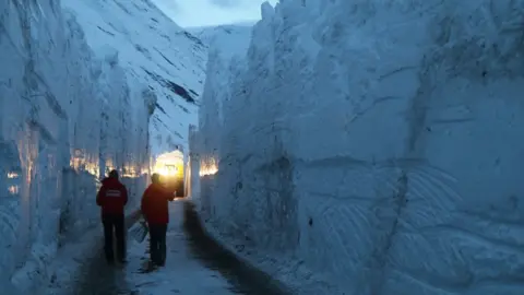 Alain Duclos Workers cut through snow wall on the Bessans to Bonneval-sur-Arc road in France