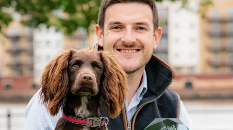 Dogs Trust and Kennel Club Bonnie, the cocker spaniel who won the public vote, with Conservative Member of the Senedd James Evans