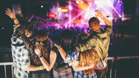 Getty Images Singing along at a music festival