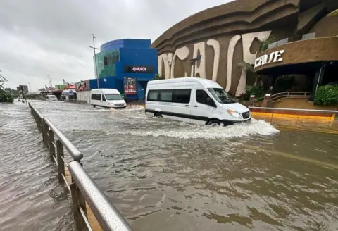 EPA Cars cross a street flooded by Hurricane Helene in the beach resort of Cancun, Quintana Roo, Mexico, 25 September 2024. 