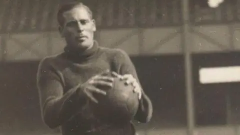 Derby County/ Kal Singh Dhindsa A black and white image of footballer John "Jack" Kirby catching a ball