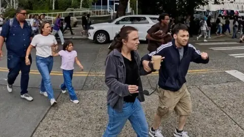 Reuters People react as they run away from the scene during an incident