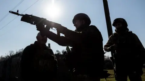 EPA-EFE/REX/Shutterstock Armed Ukrainian soldiers. Photo: October 2023