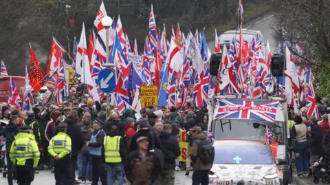 Eddie Mitchell People holding Union Jack flags and St George's Cross flags take part in a protest on a road in Crowborough.