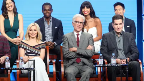 Getty Images Jameela Jamil and the cast of The Good Place with executive producer Drew Goddard