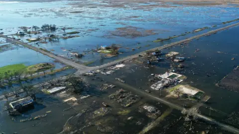 Getty Images Flood waters from Hurricane Delta surrounding buildings which had been destroyed by August's Hurricane Laura. October 10, 2020 in Creole, Louisiana