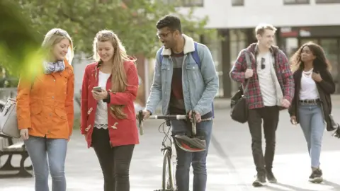 Getty Images Students walking outside university