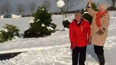 PAULINE NELMES Enid Williamson and Myrtle Gibb get in a spot of snowballing in Dromore, County Down
