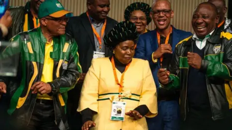 Getty Images Jacob Zuma, Nkosazana Dlamini-Zuma and Cyril Ramaphosa dancing at an ANC policy conference