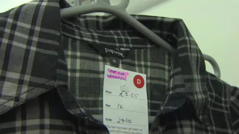 Shirt with price tag saying shop for Grenfell