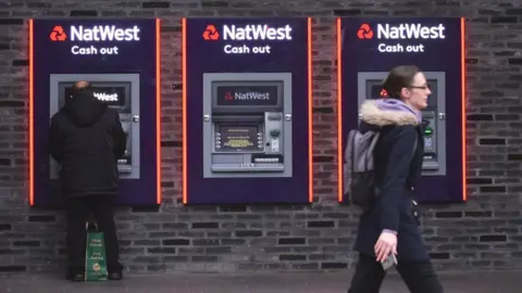 Getty Images Customers using a NatWest ATM.